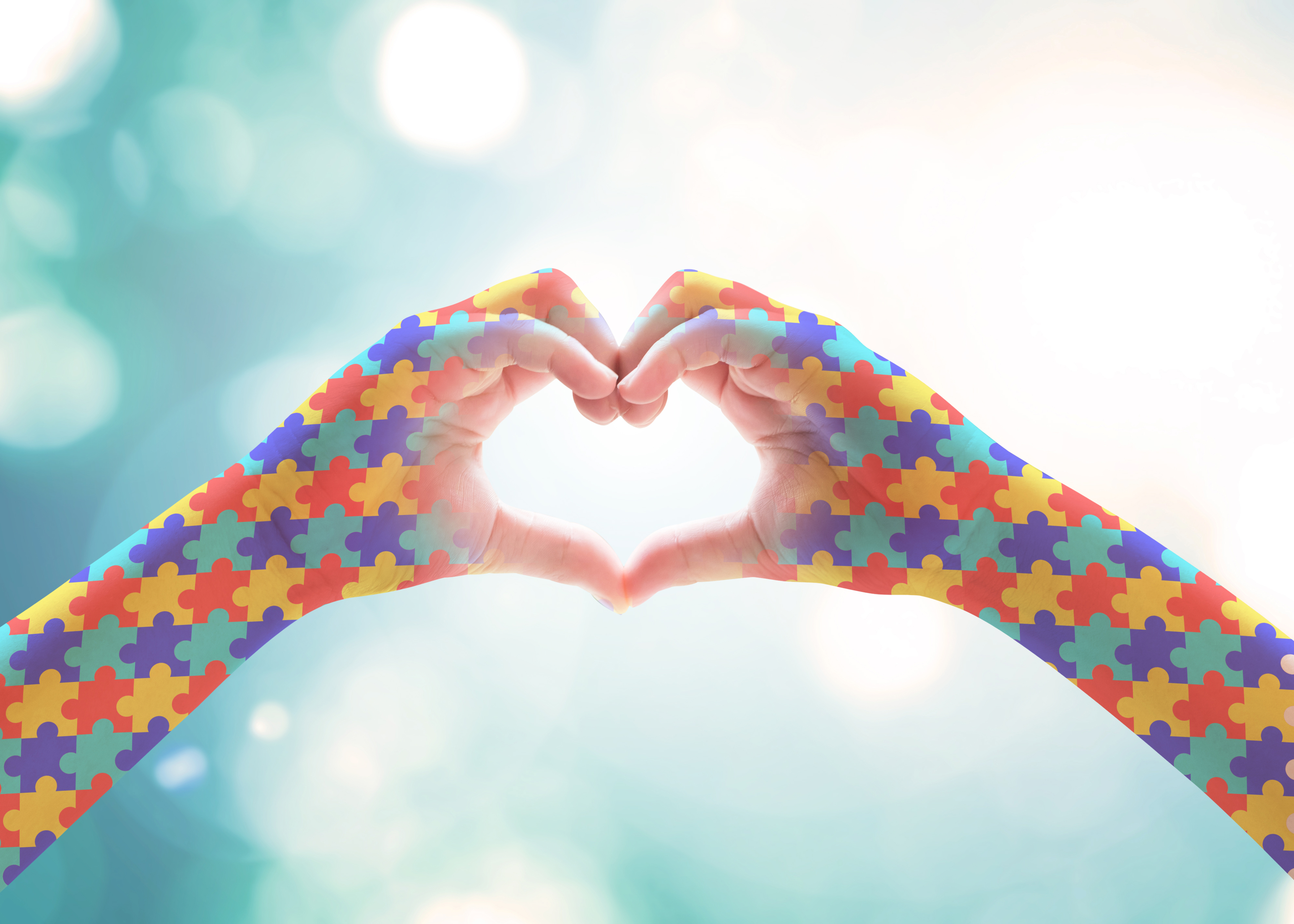 World Autism Awareness day, mental health care concept with puzzle jigsaw pattern on heart shape kid's hands for supporting autistic child medical charity campaign
